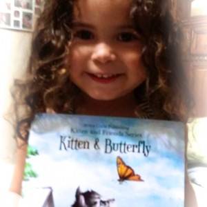 Picture of adorable child holding one of Aviva Gittle's books.